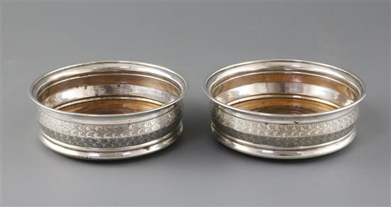 A pair of George III silver wine coasters by Soloman Hougham,